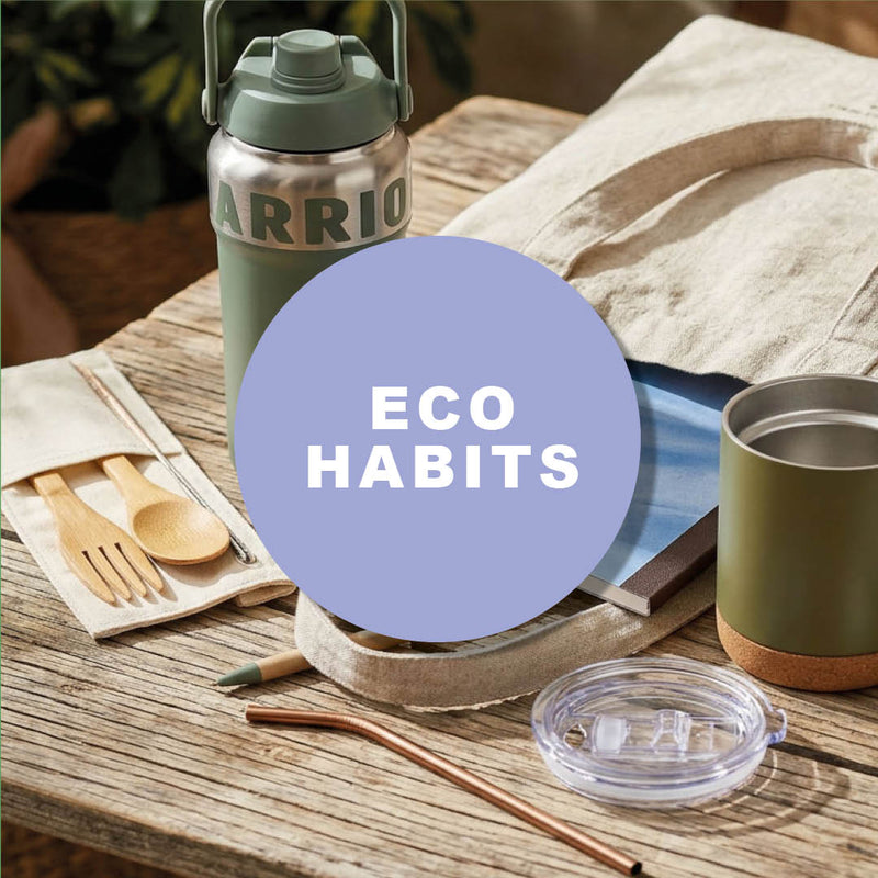 green insulated bottle with handle next to reusable cup wooden cutlery set and tote bag