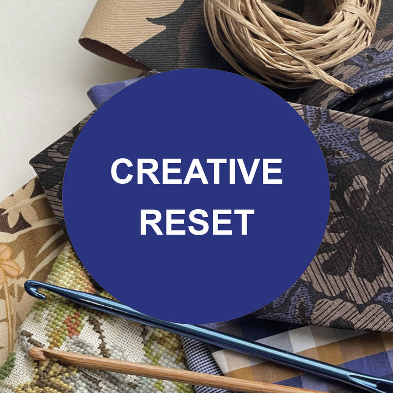 Creative craft supplies including crochet hooks, fabric pieces and natural raffia with Creative Reset text overlay
