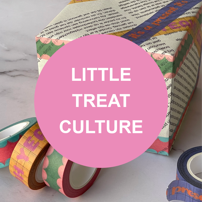 gift wrapped box with colourful patterned paper and decorative washi tape rolls around it