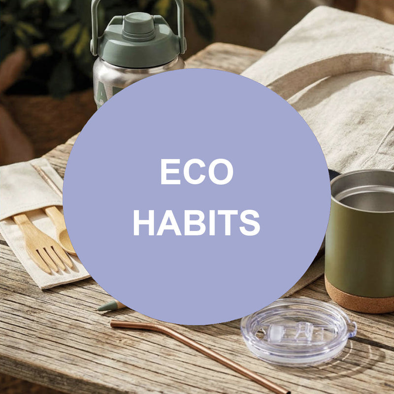 Reusable everyday essentials including stainless steel water bottle, canvas tote bag, reusable cutlery, drinking straw and travel cup with Eco Habits text overlay