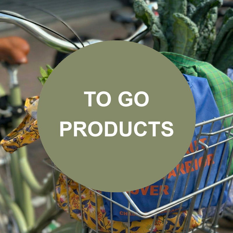 To-go products in a bicycle basket including reusable shopping bags and fresh groceries ready for everyday errands and commuting