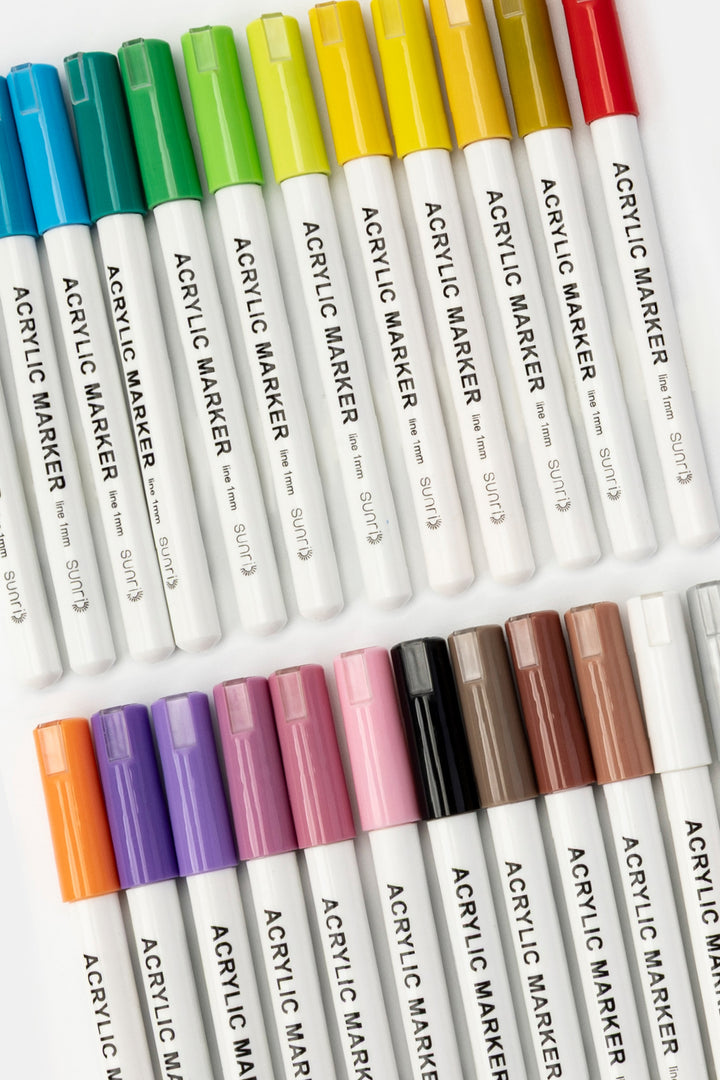set of premium acrylic markers with 1mm tips arranged by colour