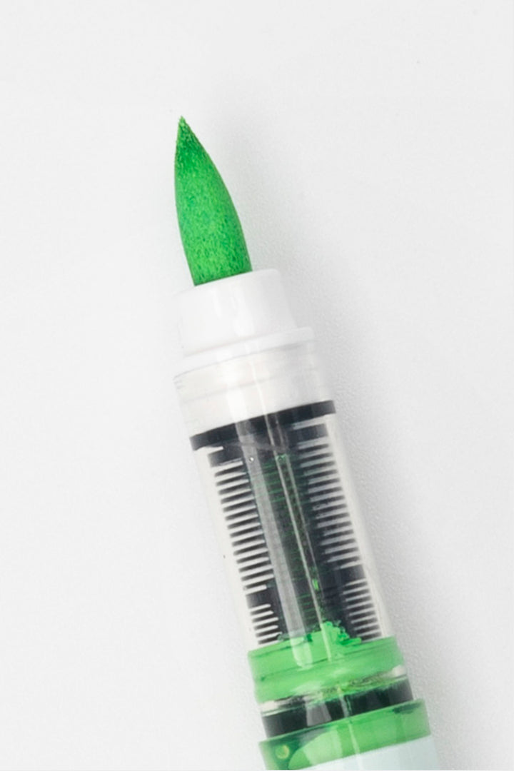 close-up of green acrylic brush tip with visible ink reservoir