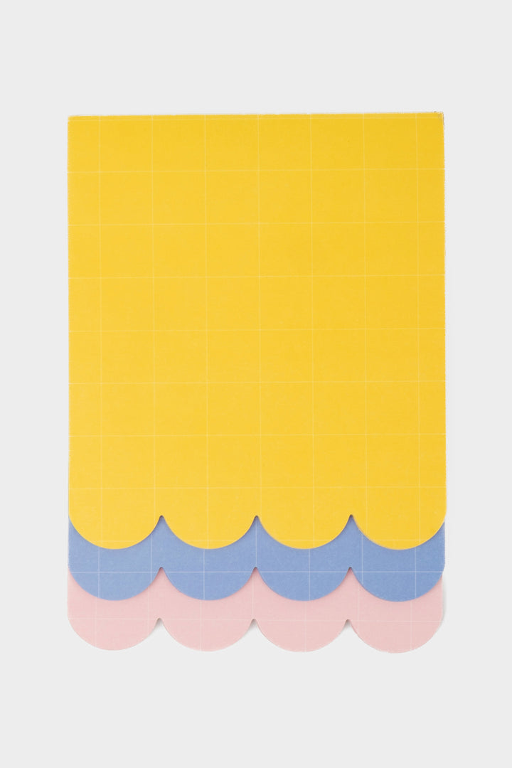 front view of three layer scalloped notepad in yellow, blue and pink with grid pattern