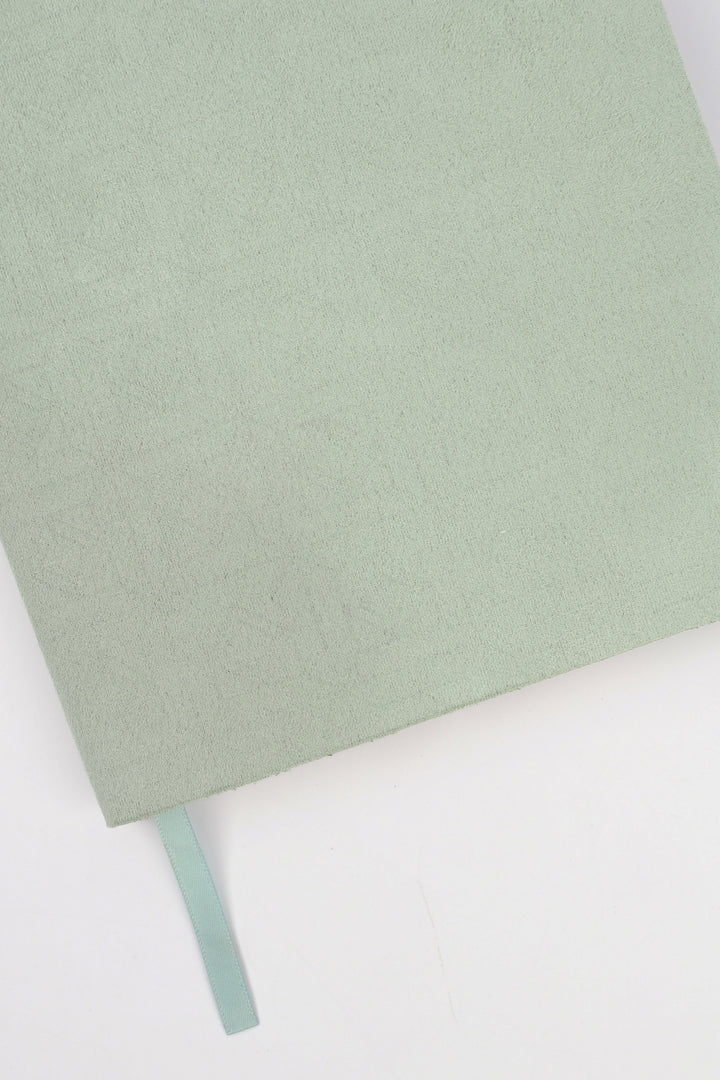 detail of green faux suede  flex-cover diary with embossed pattern 
