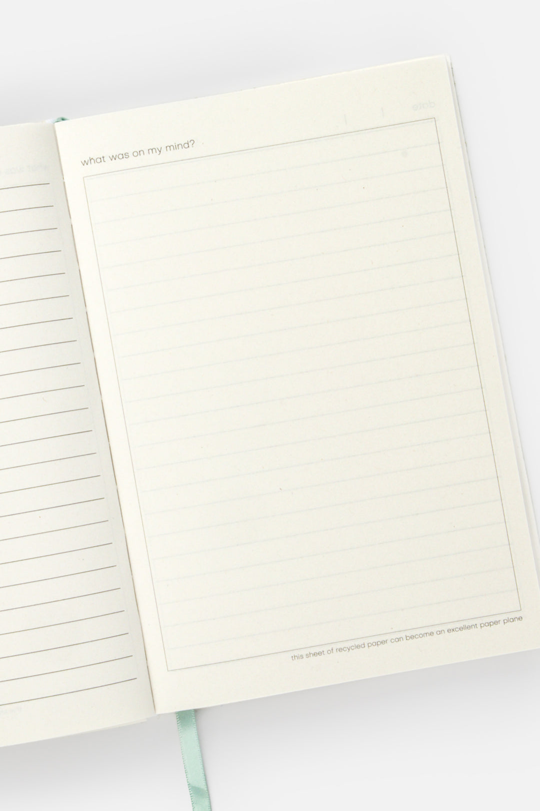 open diary with lined pages on the left and blank doodle page on the right