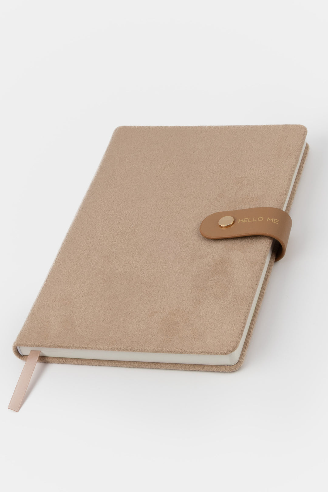front view of brown a faux-suede notebook with a rounded flap closure with gold button detail and hello me text
