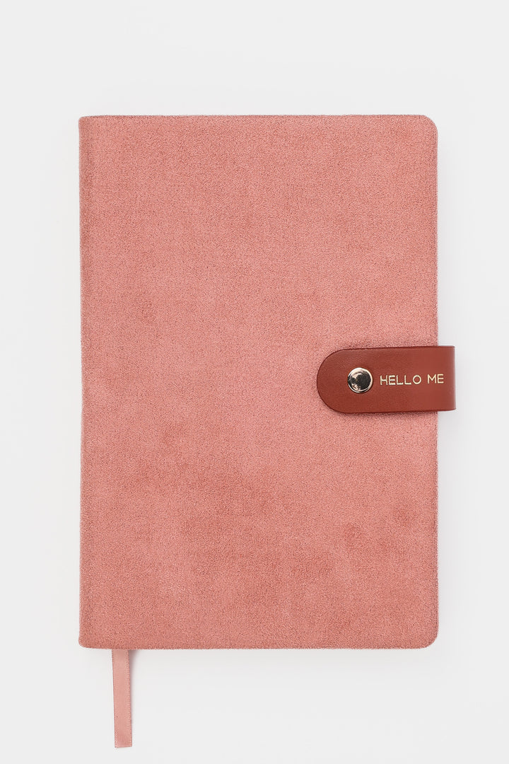 front view of a pink faux-suede notebook with a rounded flap closure with gold button detail and hello me text