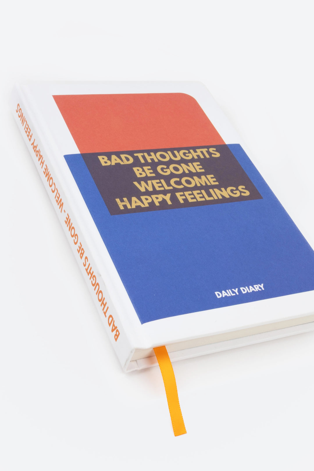 angled view of red navy and blue colour-block diary with orange ribbon marker
