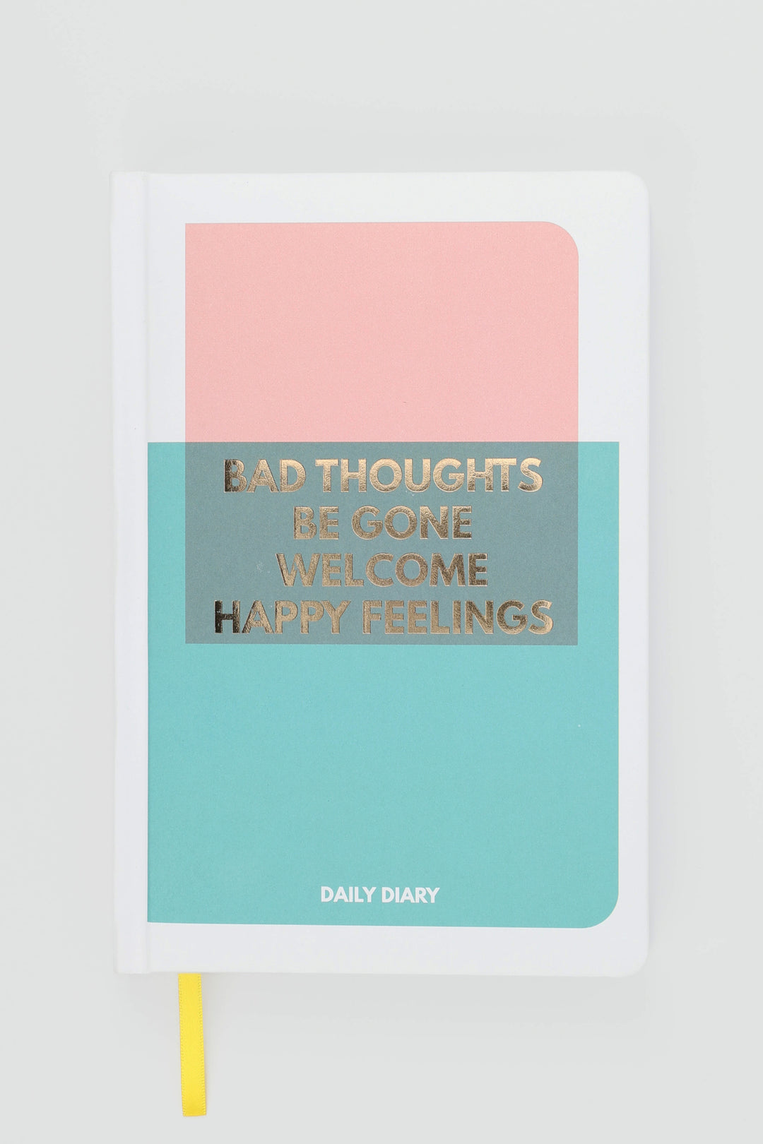 close-up of gold-foil text on pink and teal colour-block diary cover
