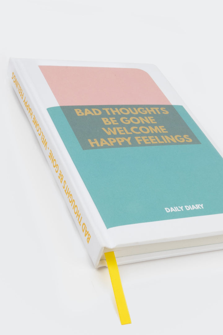 pink and teal colour-block diary with yellow ribbon marker shown at an angle
