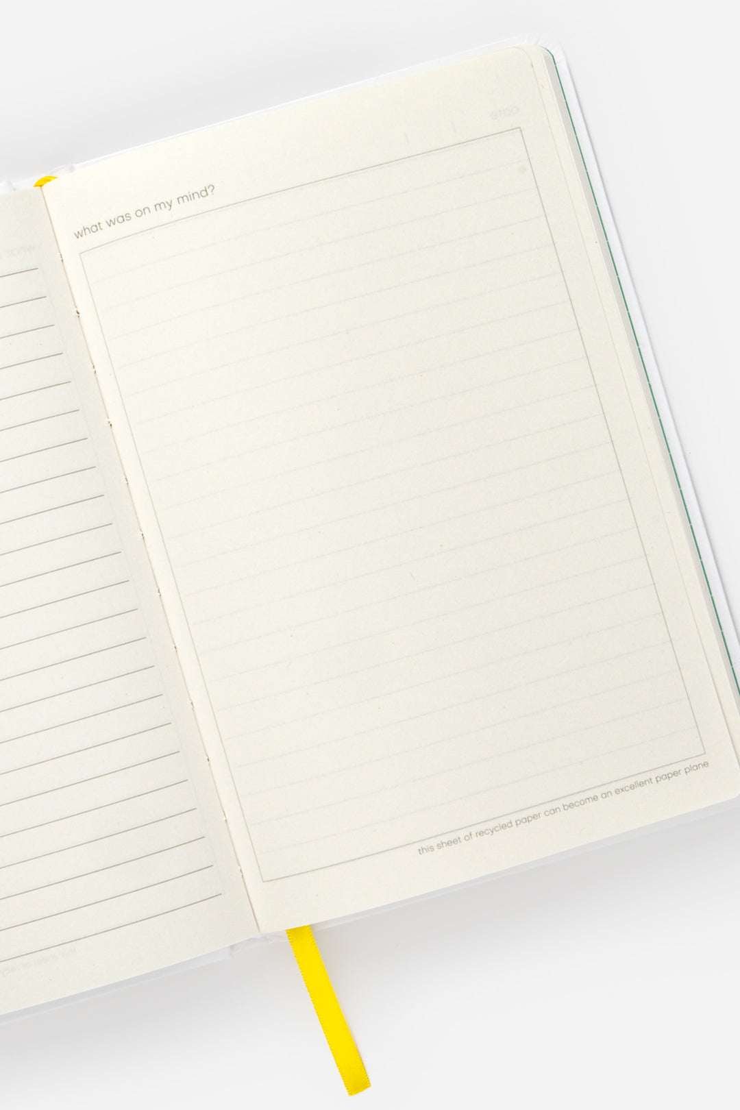 open A5 diary with lined left page and blank framed right page with yellow ribbon marker