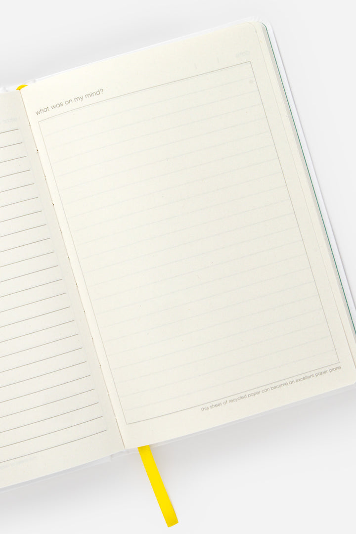 open A5 diary with lined left page and blank framed right page with yellow ribbon marker