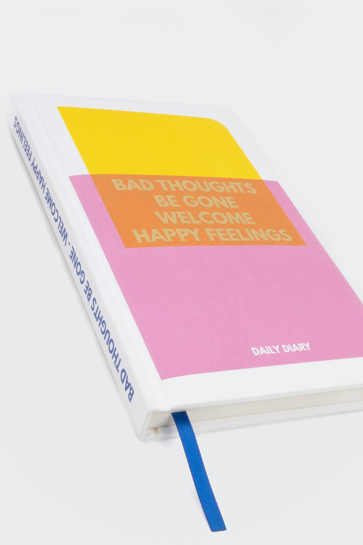 Colourful diary cover with yellow pink and orange blocks and blue ribbon marker
