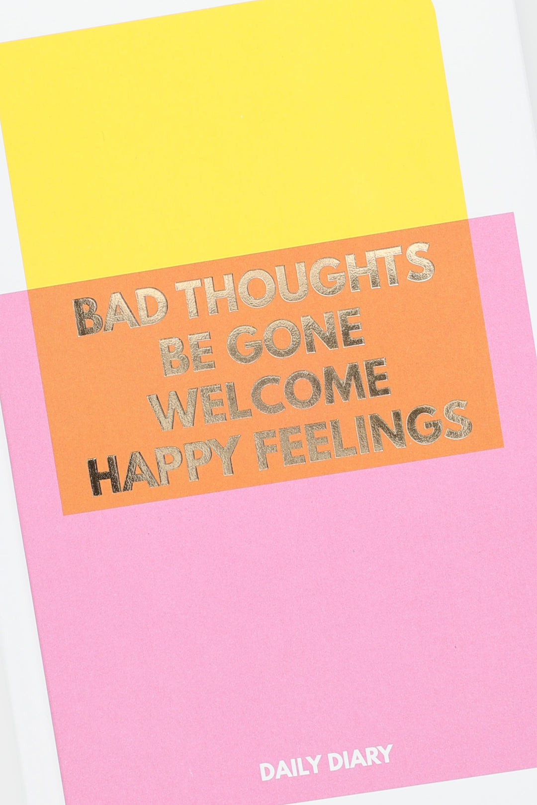 Close up of gold foil text on pink and orange diary cover