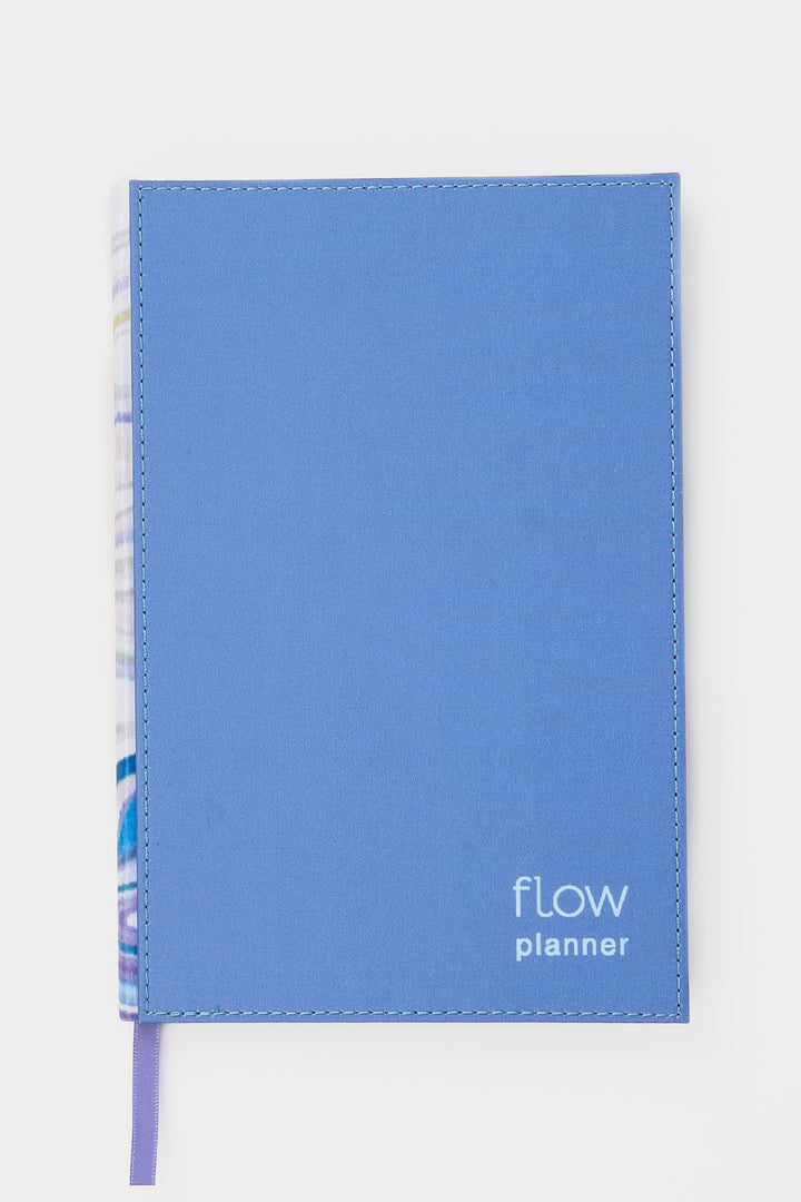 front view of a blue planner with a stitched fabric cover and matching ribbon marker
