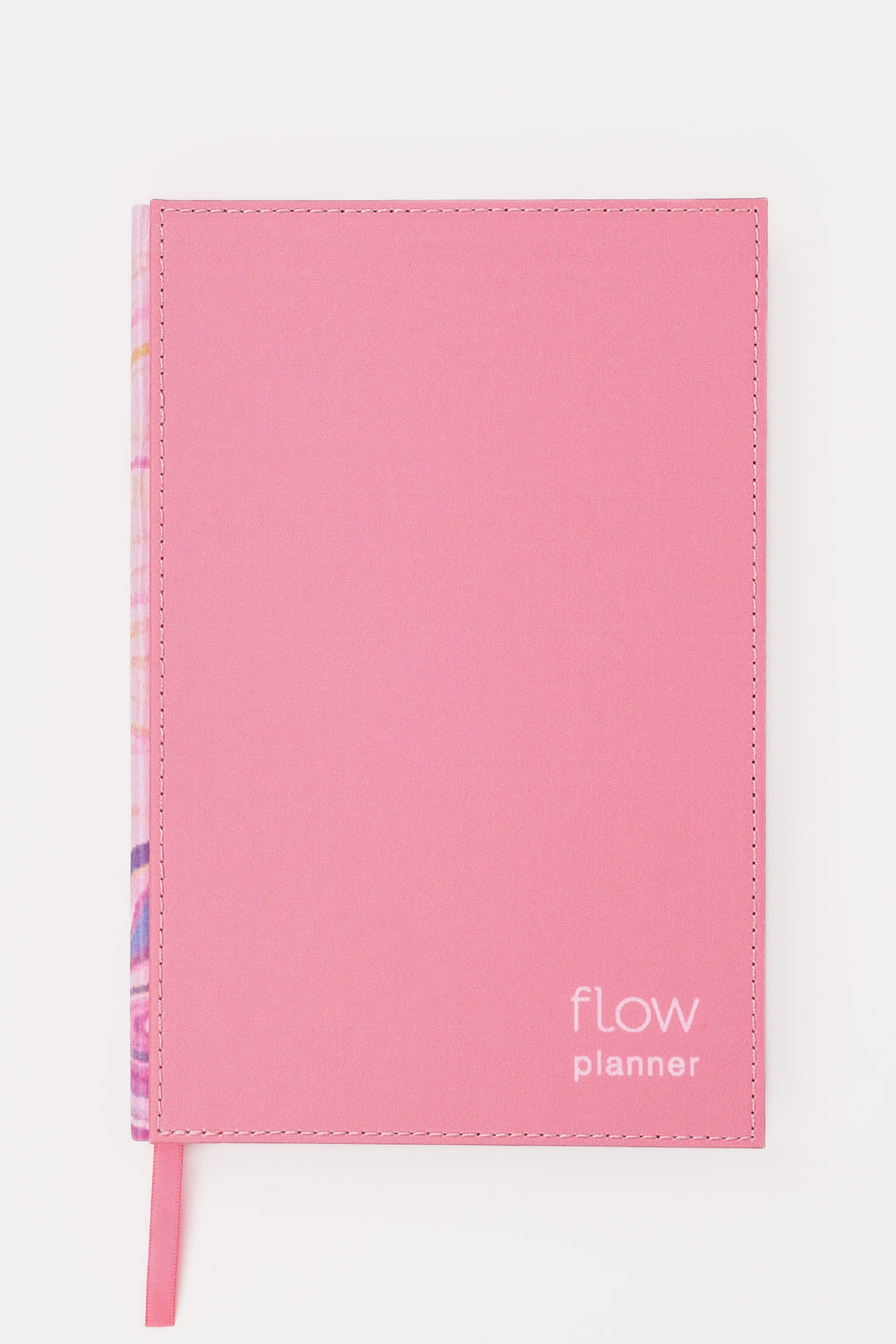 front view of a pink planner with a stitched fabric cover and matching ribbon marker
