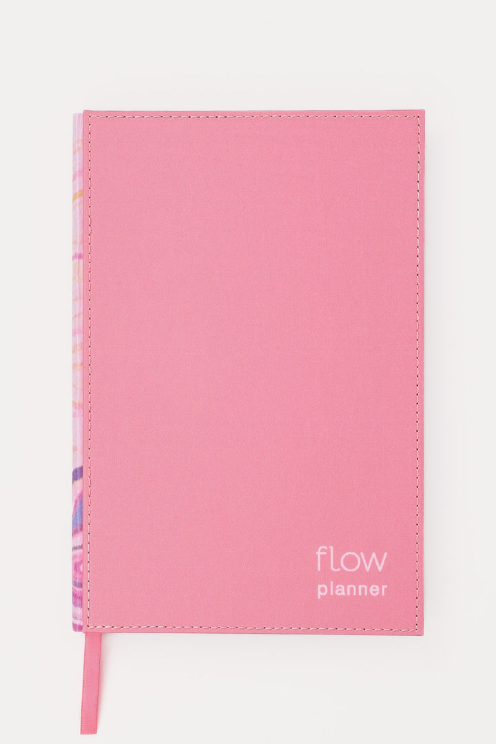 front view of a pink planner with a stitched fabric cover and matching ribbon marker
