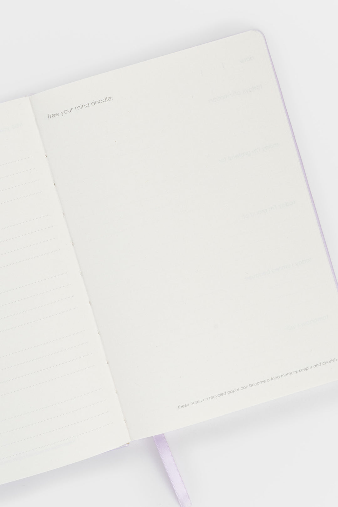 open journal showing lined pages on the left and a blank doodle page on the right