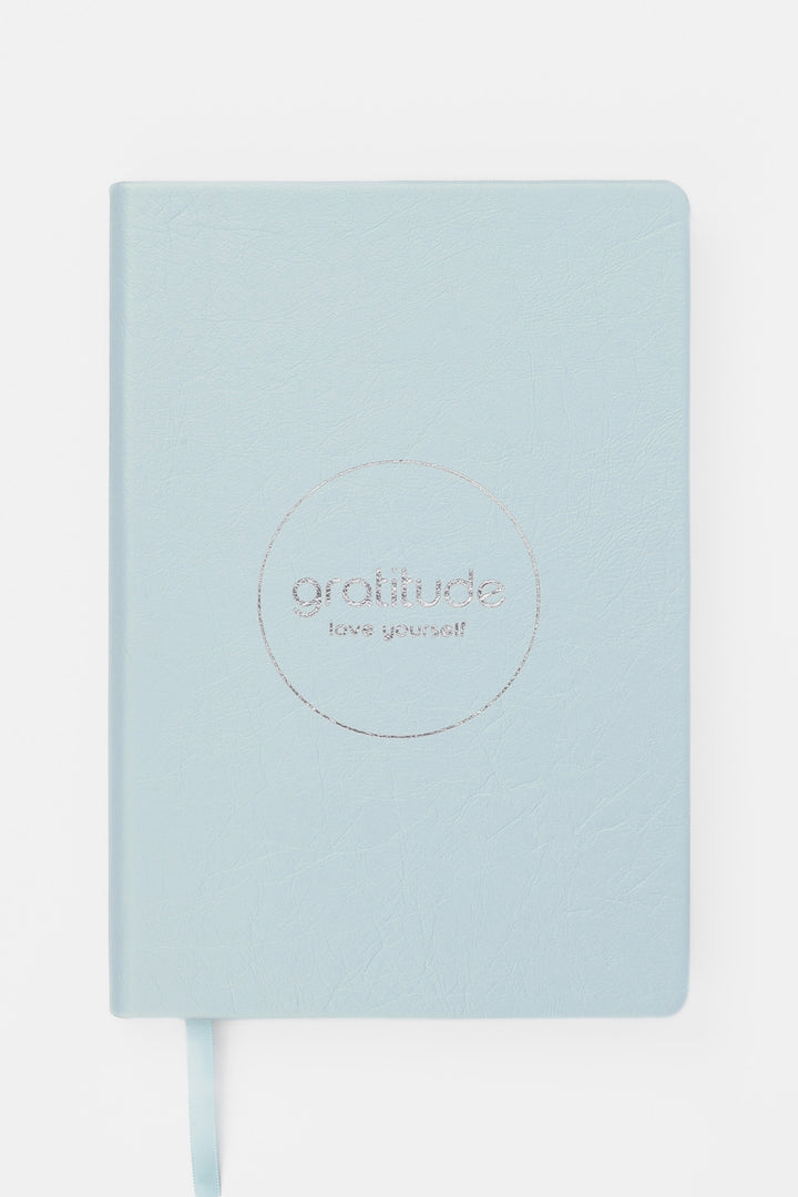 Light blue gratitude journal with 'love yourself' text 