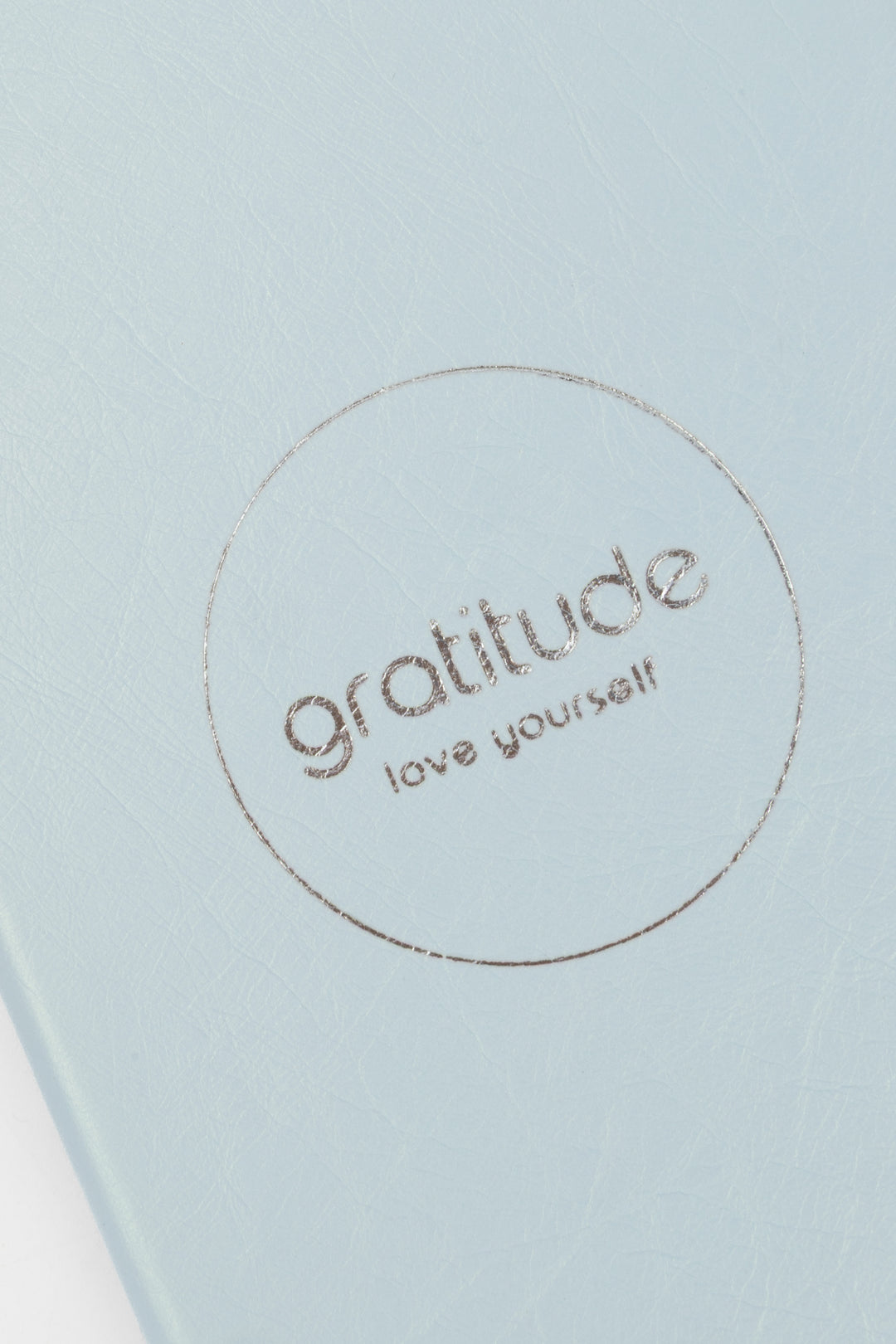 Light blue journal cover with 'gratitude love yourself' embossed text 