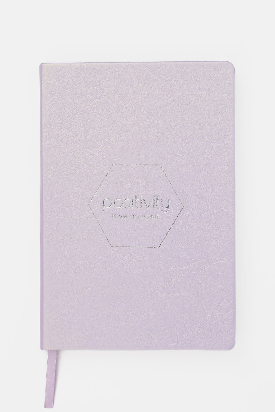 Pink notebook with 'positivity' embossed on the cover 