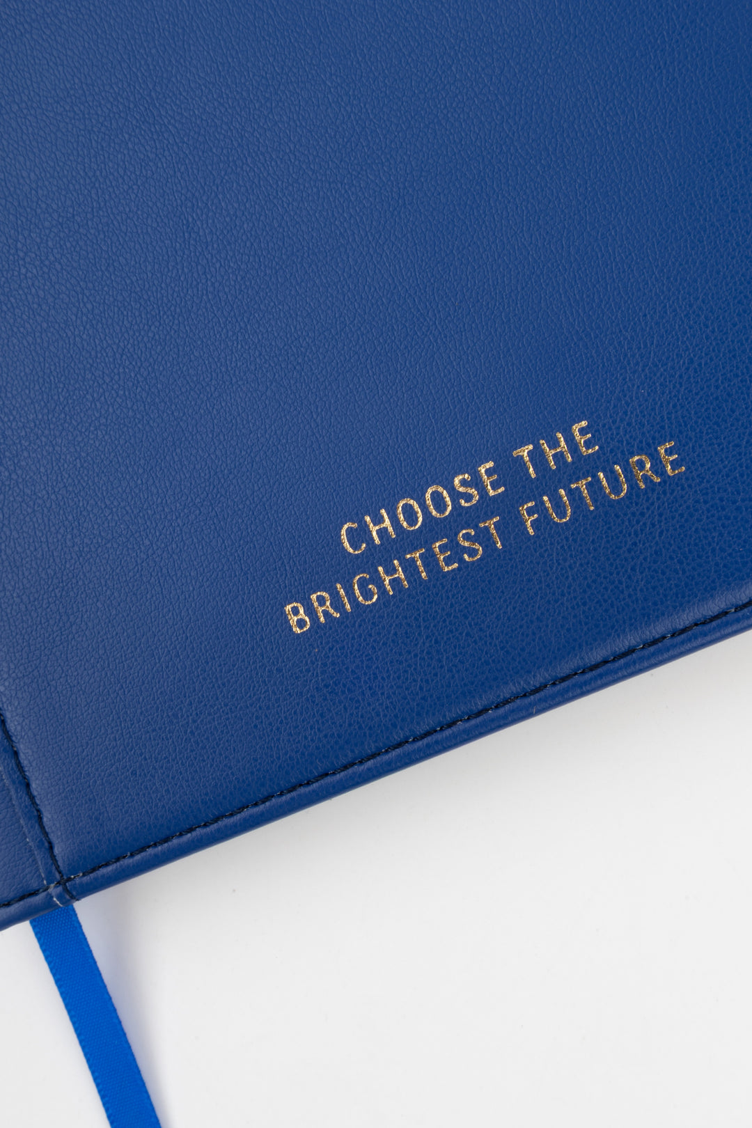 close-up of blue PU notebook cover showing embossed choose the brightest future text

