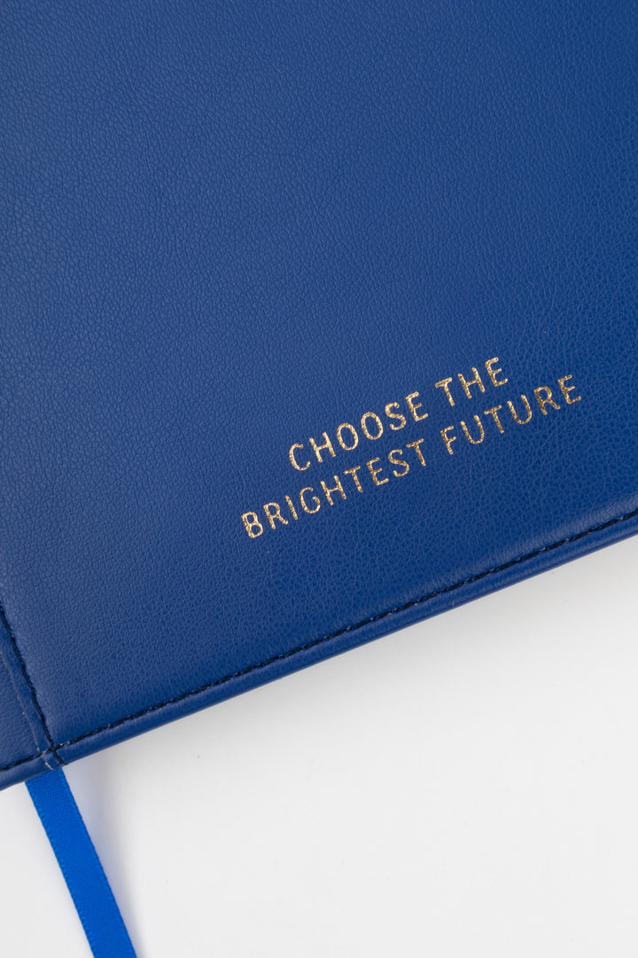 close-up of blue PU notebook cover showing embossed choose the brightest future text

