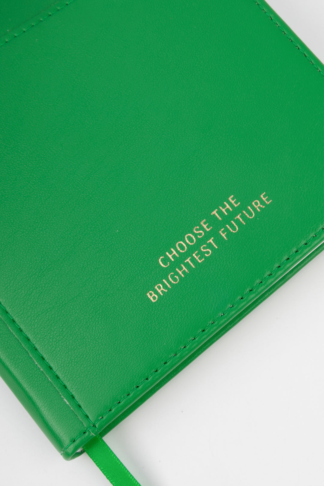 close-up of green PU notebook cover showing embossed choose the brightest future text
