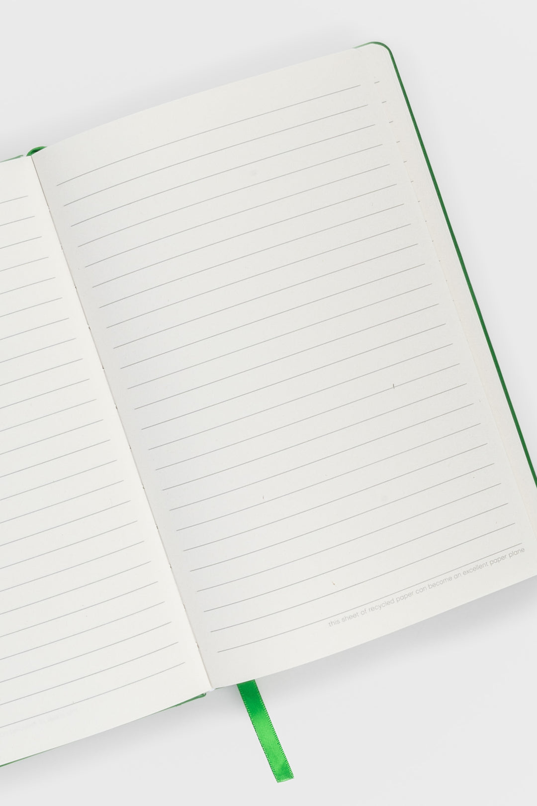 open A5 notebook with ruled pages and  satin marker visible
