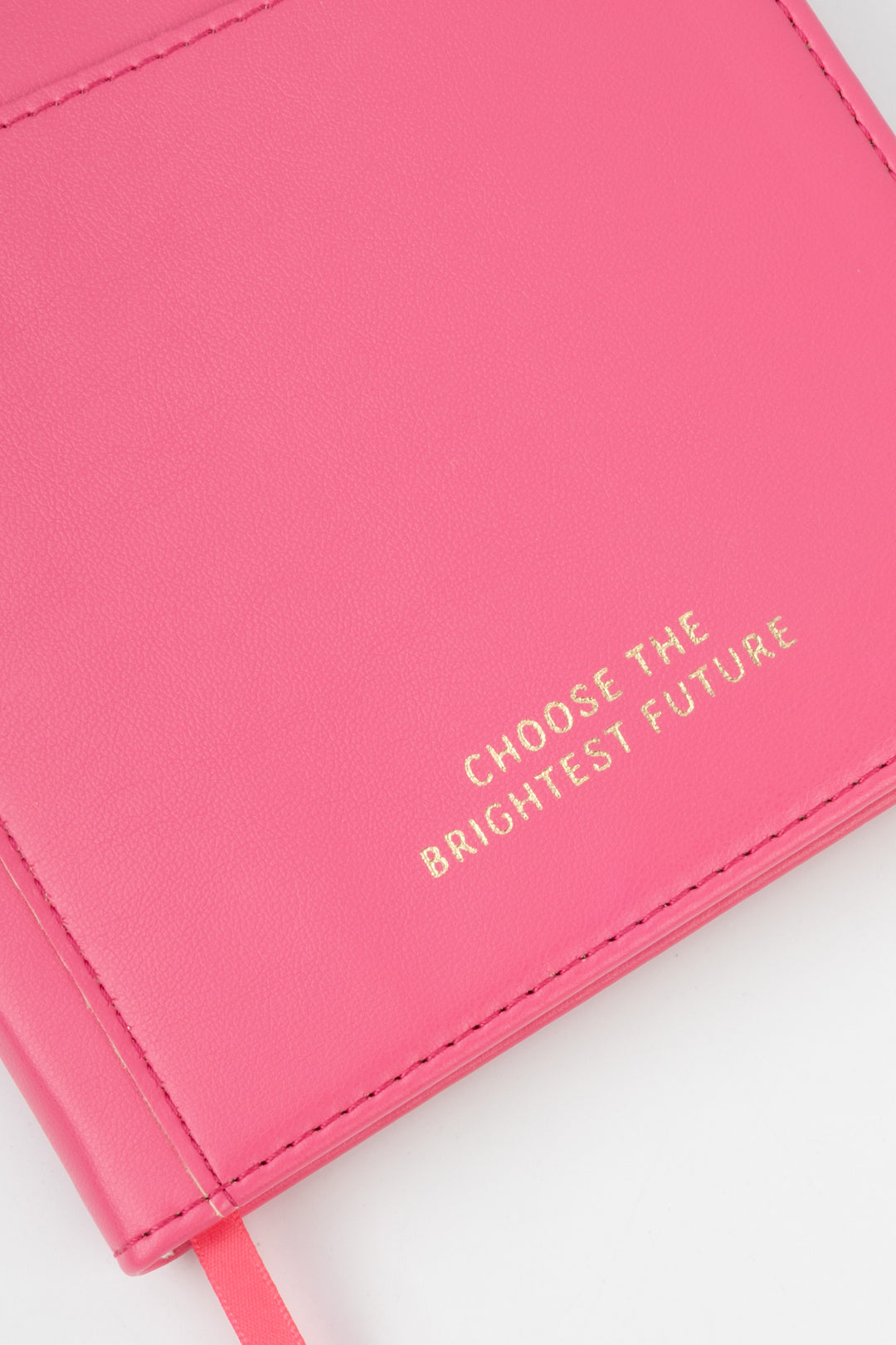 close-up of pink PU notebook cover showing embossed choose the brightest future text
