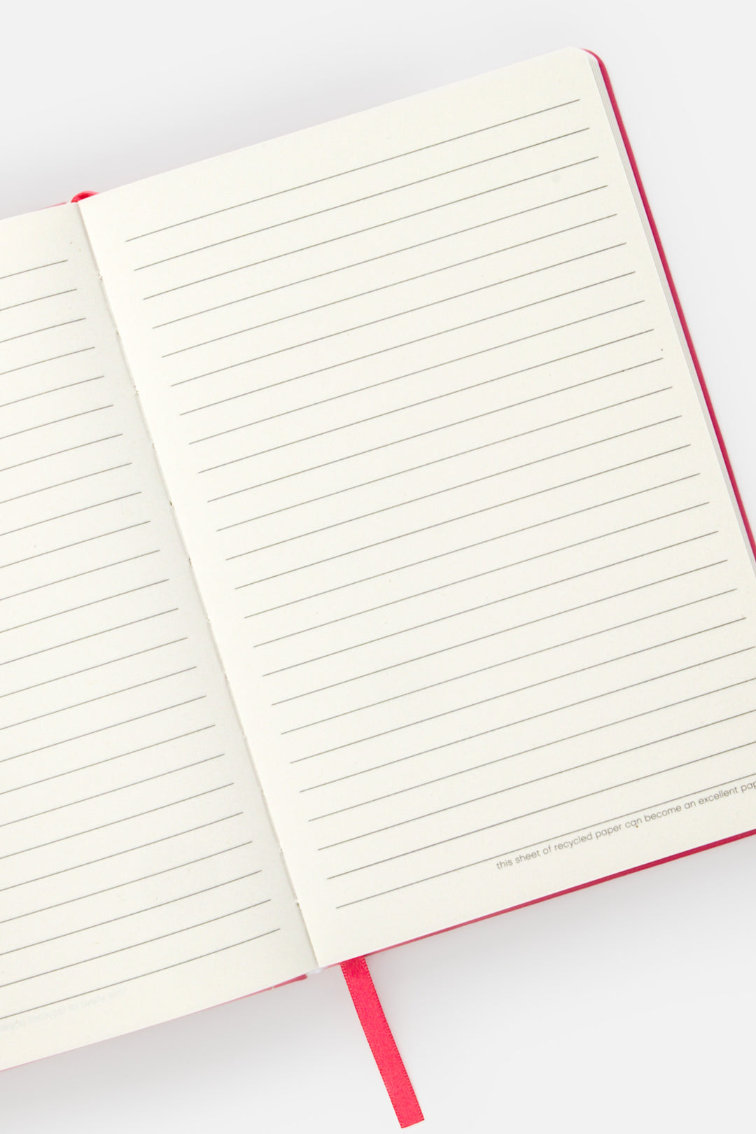 open A5 notebook with ruled pages and  satin marker visible
