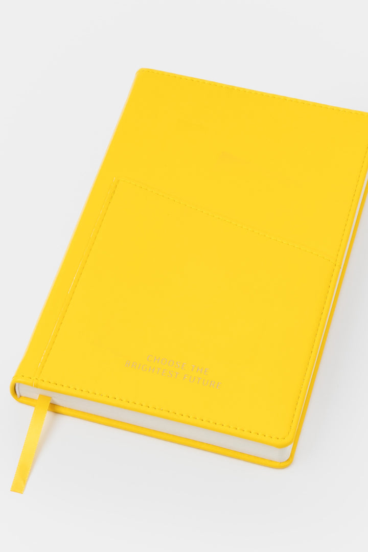 A5 yellow PU leather notebook shown angled with visible front pocket and satin page marker
