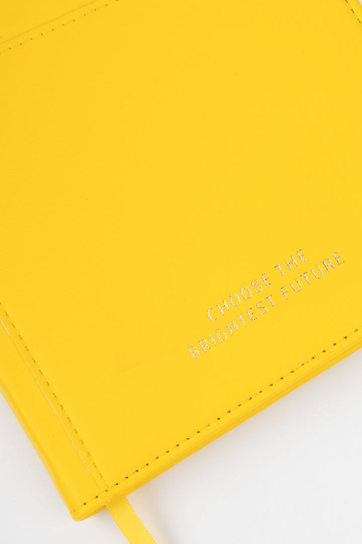 close-up of yellow PU notebook cover showing embossed choose the brightest future text
