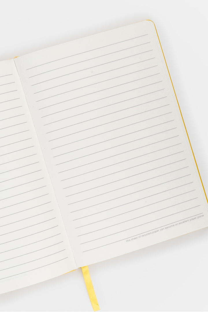open A5 notebook with ruled pages and  satin marker visible
