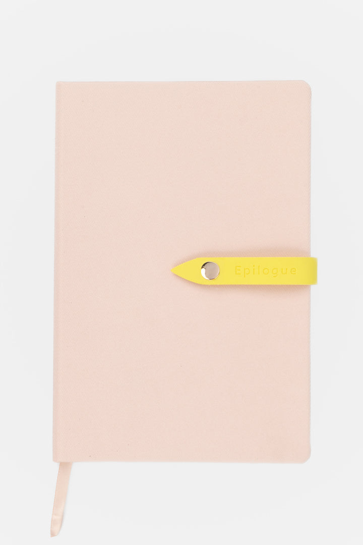 pink journal with a yellow strap and metal push button