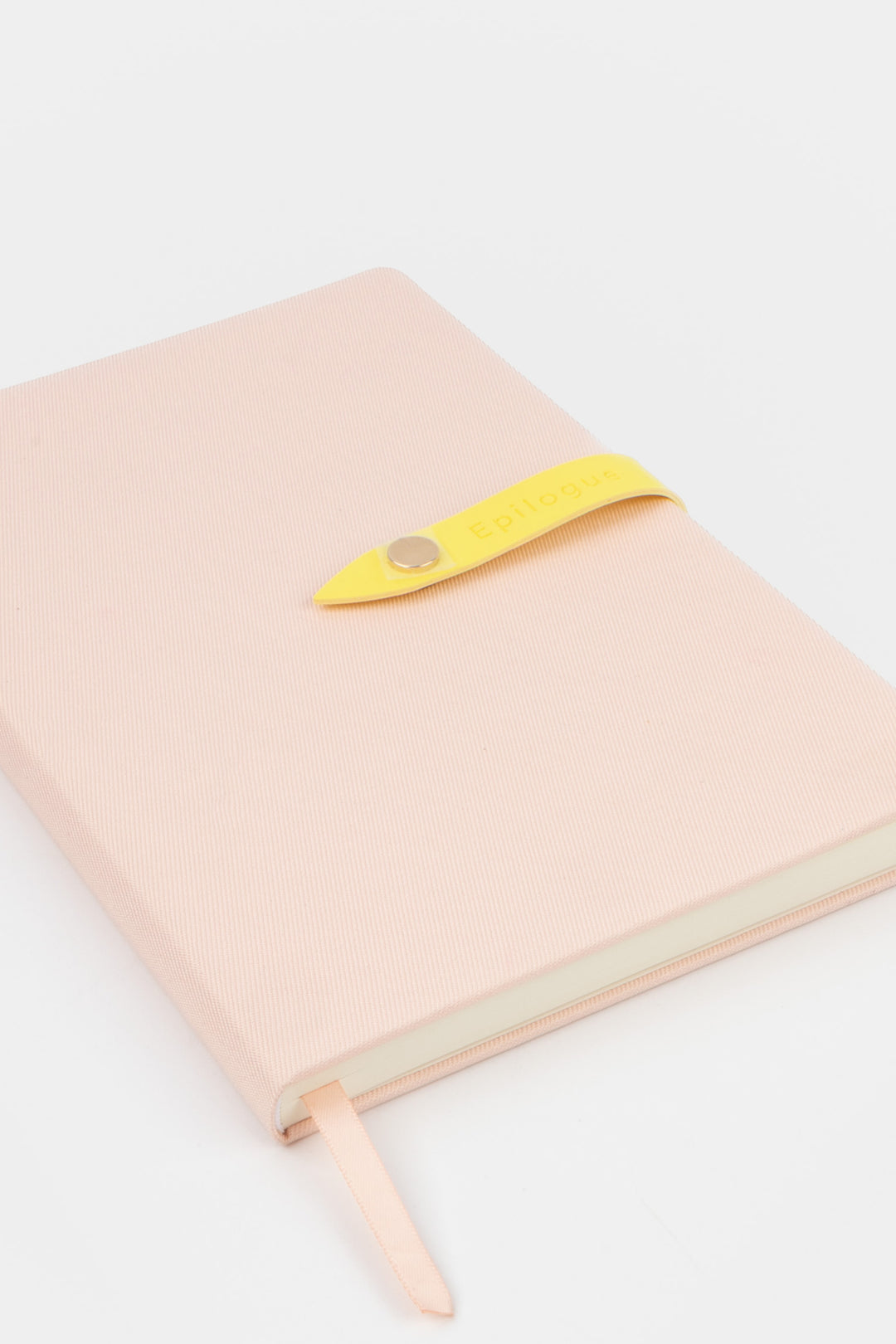 pink journal with a yellow strap and metal push button