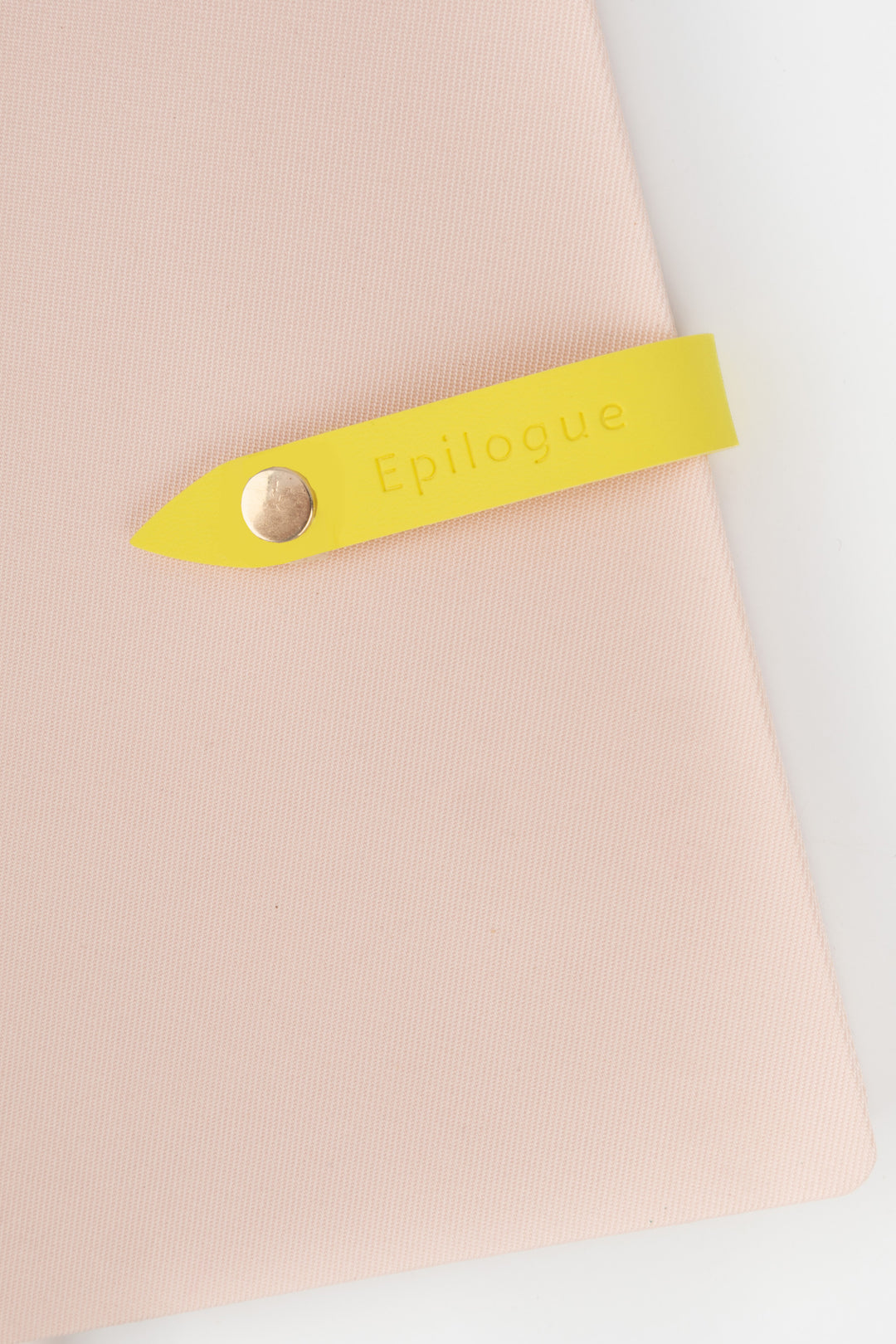 Yellow strap with 'Epilogue' branding on a light pink background
