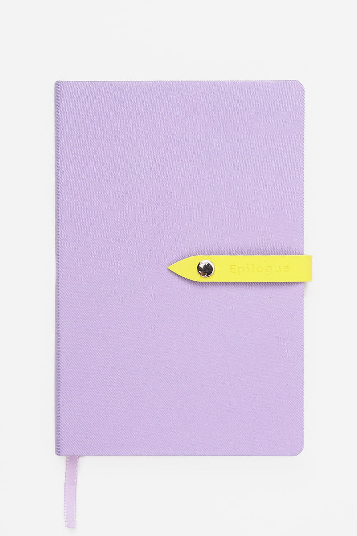 purple journal with a yellow strap and metal push button