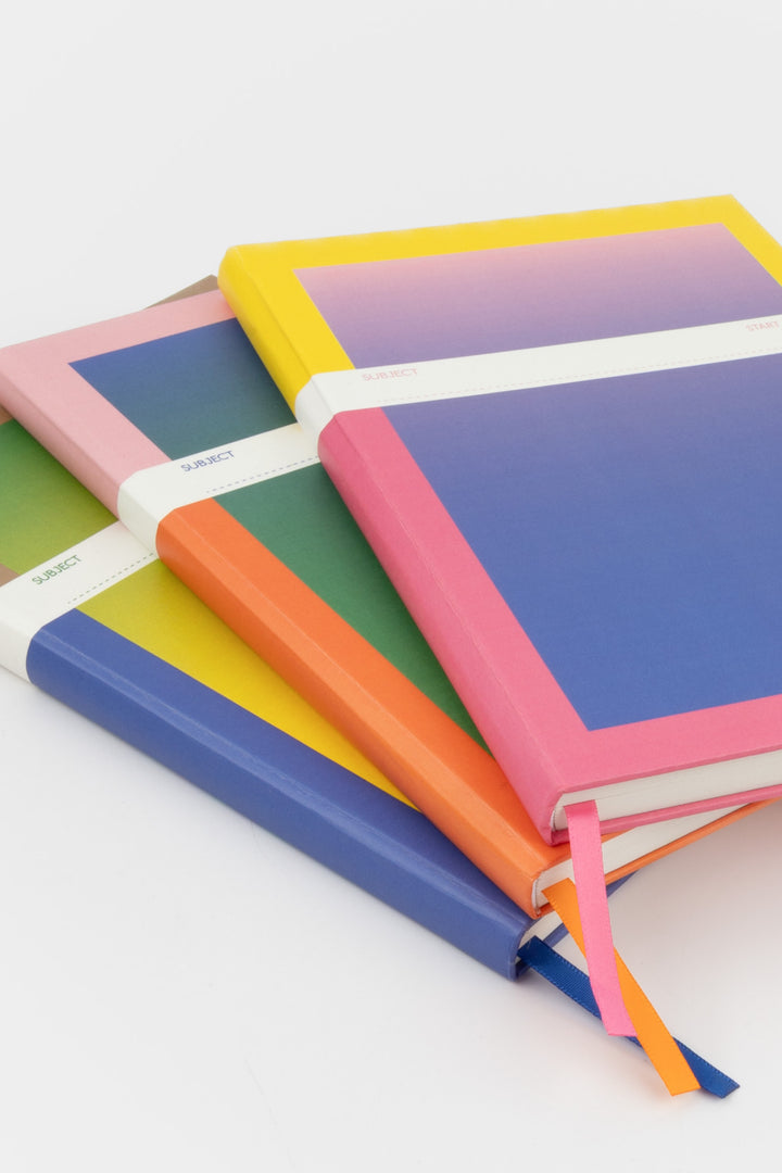 stack of a5 notebooks with gradient covers and mixed satin page markers

