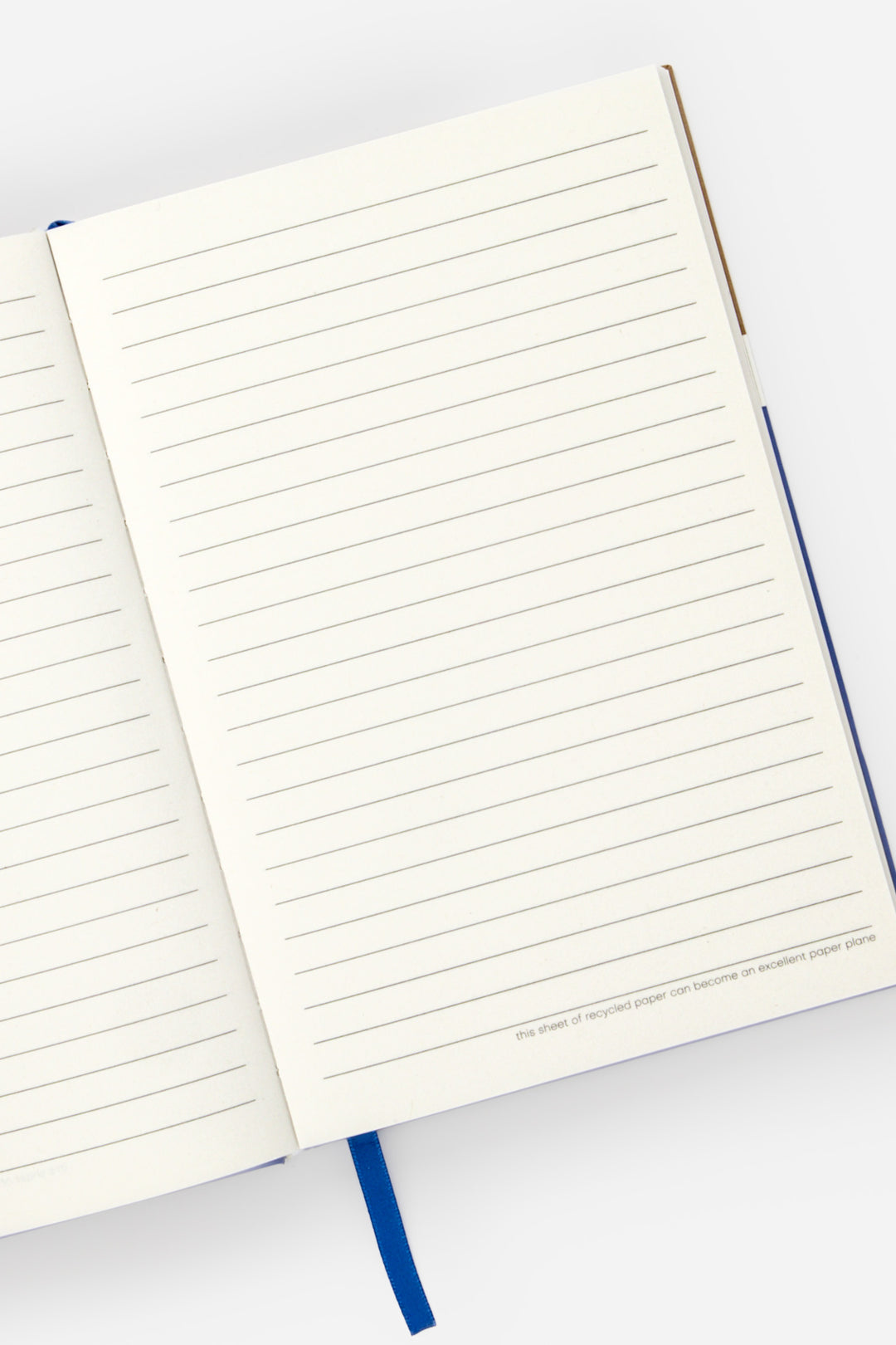 open a5 notebook with ruled recycled paper and blue satin page marker
