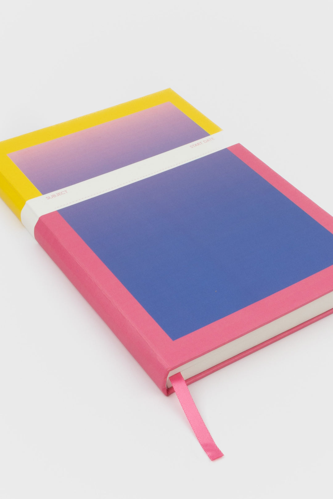 A5 notebook with yellow and pink gradient cover and pink page marker

