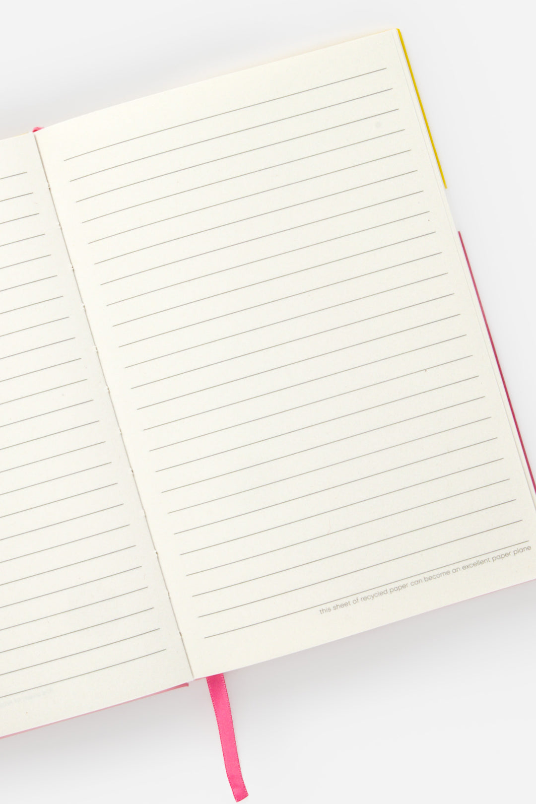open A5 notebook with lined pages and pink page marker