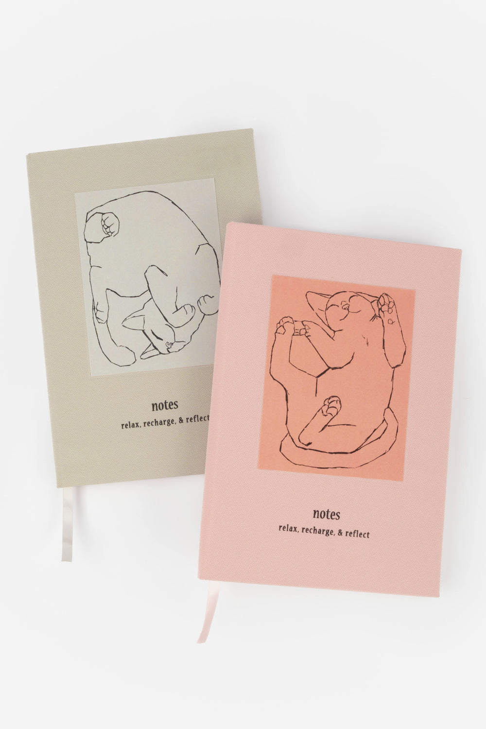 Two notebooks with happy cat illustrations on grey and pink covers.
