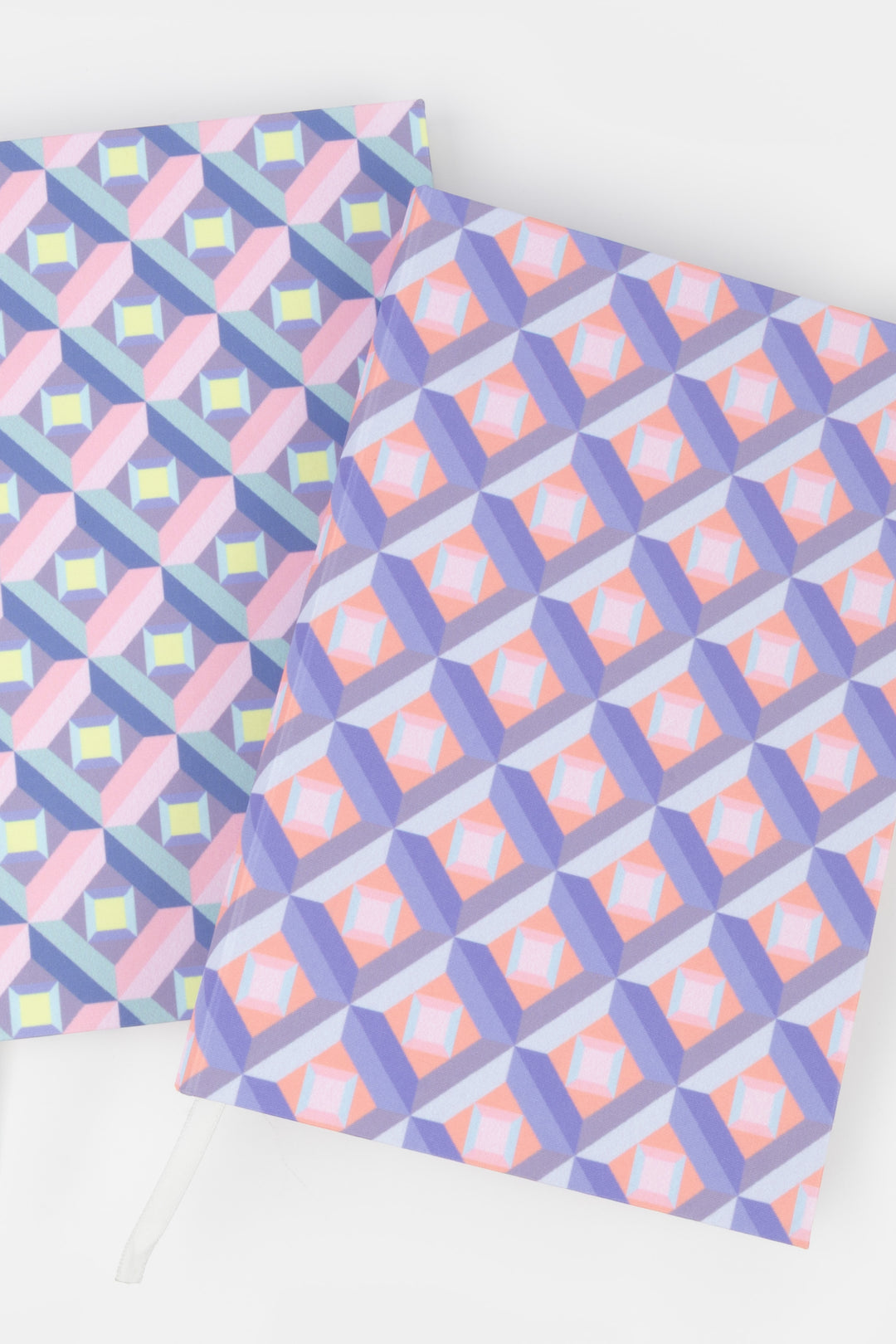 Two A5 optical print notebooks side by side, one pink and purple, one multicolour
