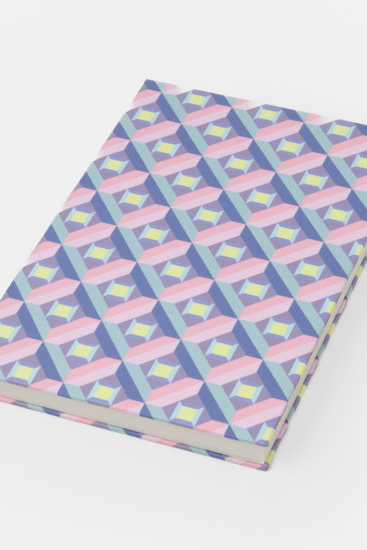 A5 hardcover notebook with pink and purple optical geometric print shown closed
