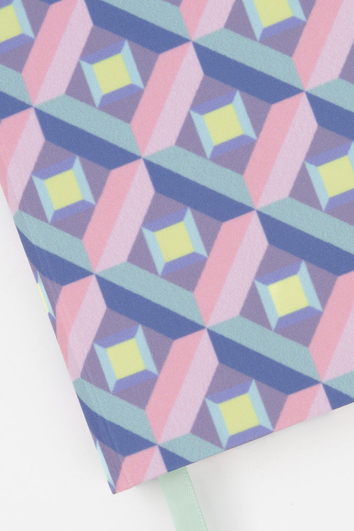 Close-up of the pink and purple optical geometric print on the A5 hardcover notebook
