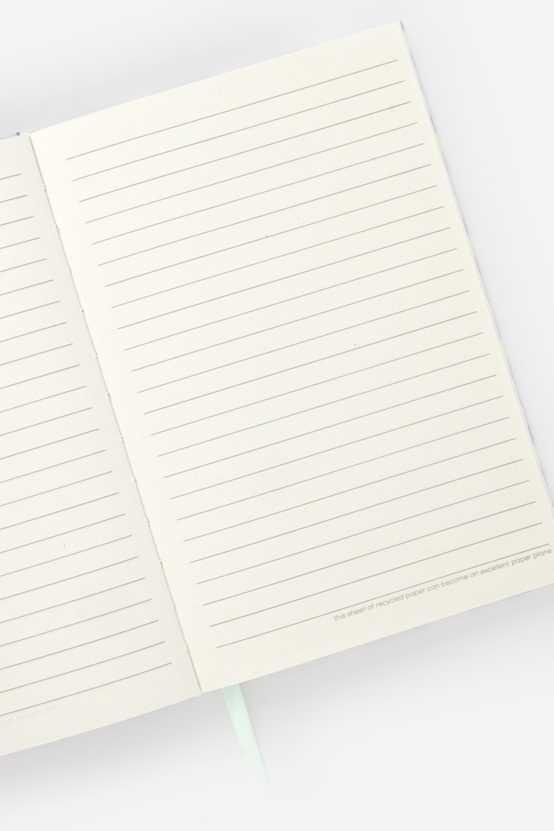 Open A5 notebook with ruled recycled paper pages and ribbon marker visible