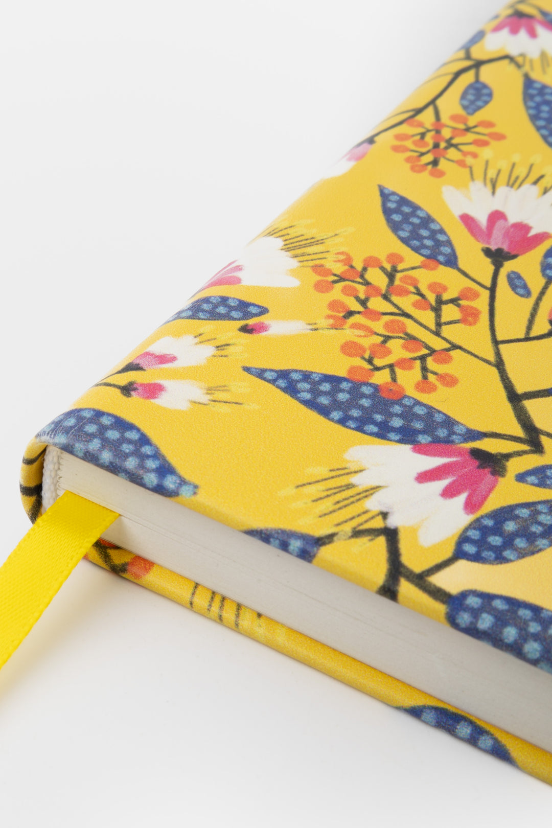 close-up of the yellow floral cover and ribbon marker near the bottom edge
