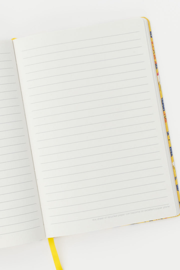 open notebook showing ruled pages with the yellow ribbon marker visible at the bottom
